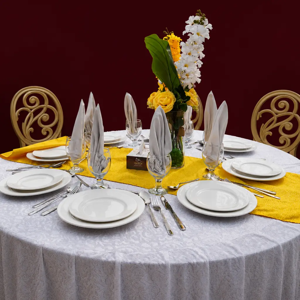 plates , glasses , nappkins , spoons on white table